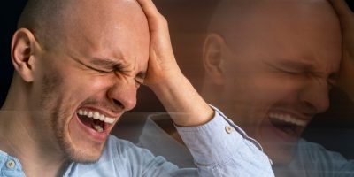 Close-up portrait of a man expressing the challenges of living with schizophrenia.