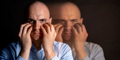 Intimate portrait of a man showing signs of distress related to schizophrenia.